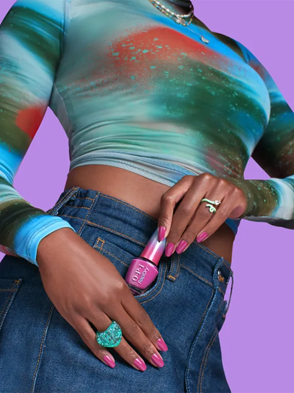 Woman takes an OPI nail polish out of her skirt pocket