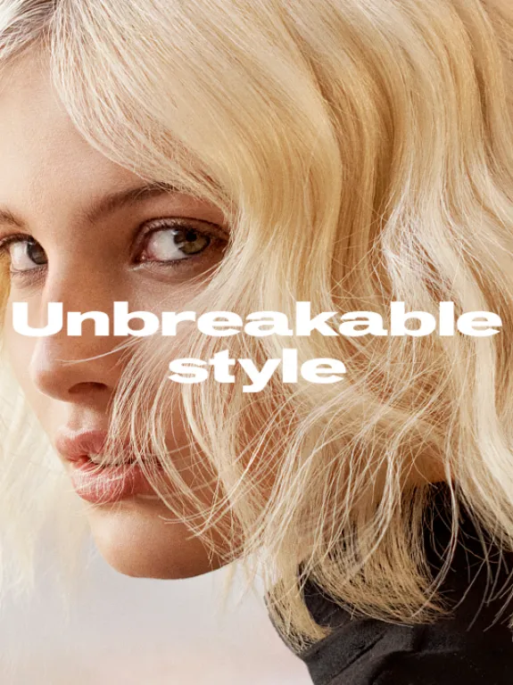 Model with short, blonde wavy hair looking to the side, Text overlay reads 'Unbreakable style'.