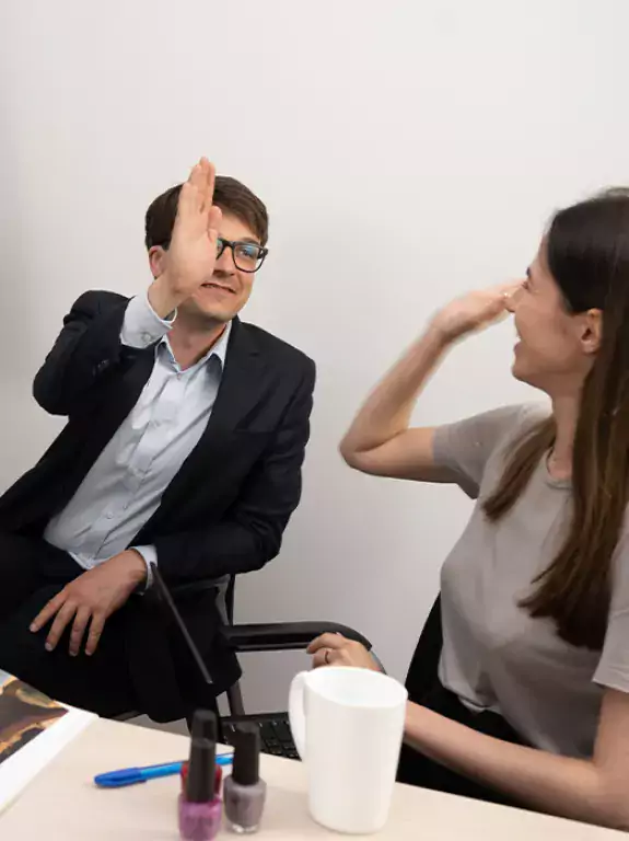 Employees in office giving a high five