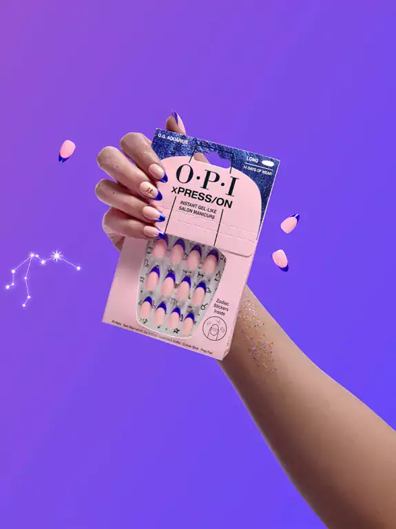 Hand holding an OPI product on a purple background